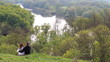 Vídeo: Romantic young couple sitting together in forest Romantic young couple sitting together in forest