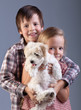 Happy kids holding their new pet
