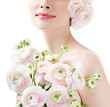 fashion model with hairstyle and pink flowers in her hair.