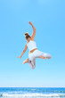 Photo: woman jumping on the beach woman jumping on the beach