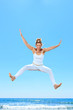 Photo: woman jumping on the beach woman jumping on the beach