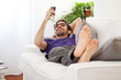 Young man stretching comfortably on couch