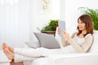 Young woman working with a digital tablet at home