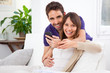 Young couple with a smartphone at home