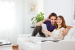 Young couple with digital tablet at home