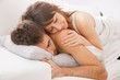 Portrait of a young couple sleeping on bed