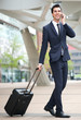 Young businessman traveling with phone and bag