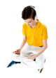 Slim kid listening to music via tablet device