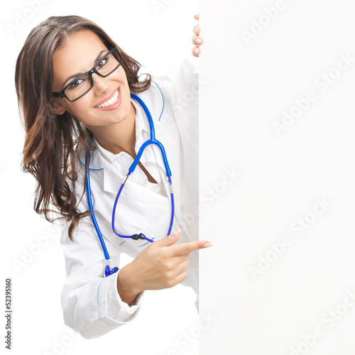 Photo: Doctor showing blank signboard, isolated Doctor showing blank signboard, isolated