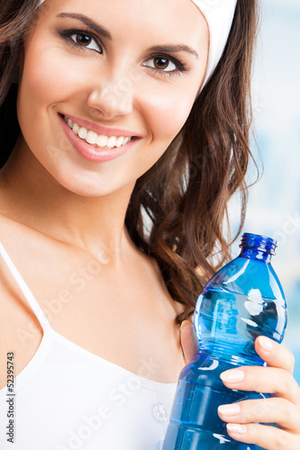 Photo: Woman with bottle of water, at fitness club Woman with bottle of water, at fitness club