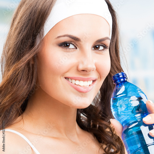 Photo: Woman drinking water, at fitness club Woman drinking water, at fitness club