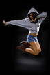 latina dancer wearing a hoodie jumping. 