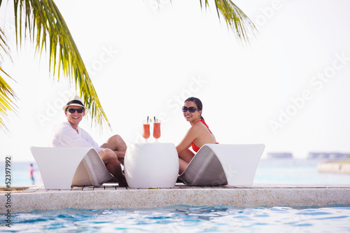 Photo: happy young couple have fun on beach happy young couple have fun on beach
