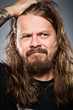 Caucasian Man With Long Hair Looking Confused