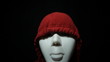 Furious masked man over dark background