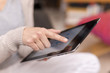 Woman hand touching screen on digital tablet.