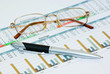 Pen and glasses on diagramm