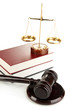 Golden scales of justice, gavel and books isolated on white