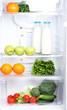 Open refrigerator with vegetarian food