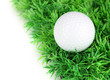 Golf ball on grass isolated on white