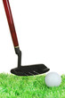 Golf ball and driver on grass isolated on white