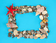 Frame of sea stones on color background