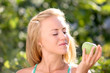 beautiful happy smiling woman with green apple
