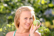 happy smiling woman with green apple, outdoors