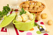 Tender young potatoes with sour cream and herbs in pan