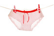 Women's panties hanging on rope isolated on white