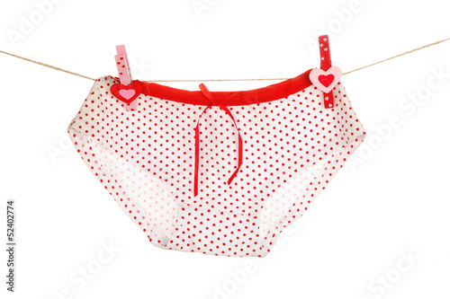 Photo: Women's panties hanging on rope isolated on white Women's panties hanging on rope isolated on white