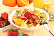 Useful fruit salad of fresh fruits and berries in bowl