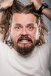 Caucasian Man With Pulling Out His Long Hair
