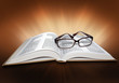 Open Bible, with cross symbol and glasses