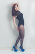 fashion model striking a pose in blue high heels