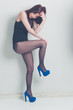 fashion model striking a pose in blue high heels