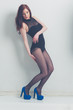 fashion model striking a pose in blue high heels