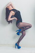 fashion model striking a pose in blue high heels