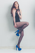 fashion model striking a pose in blue high heels