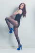 fashion model striking a pose in blue high heels