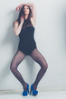 fashion model striking a pose in blue high heels