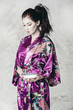 a brunette in traditional asian clothing and makeup