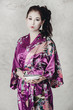 a brunette in traditional asian clothing and makeup