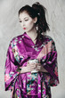 a brunette in traditional asian clothing and makeup