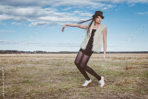 Photo: fashion model posing outdoor in a rural setting fashion model posing outdoor in a rural setting