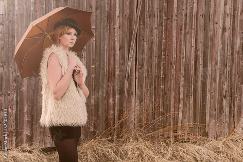 Photo: fashion model posing outdoor in a rural setting fashion model posing outdoor in a rural setting