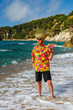senior man with cocktail drink at the beach