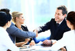 Two business colleagues shaking hands during meeting