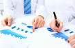 Foto: Two business people discuss financial Two business people discuss financial