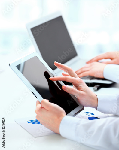 Photo: Image of confident partners working with modern Image of confident partners working with modern